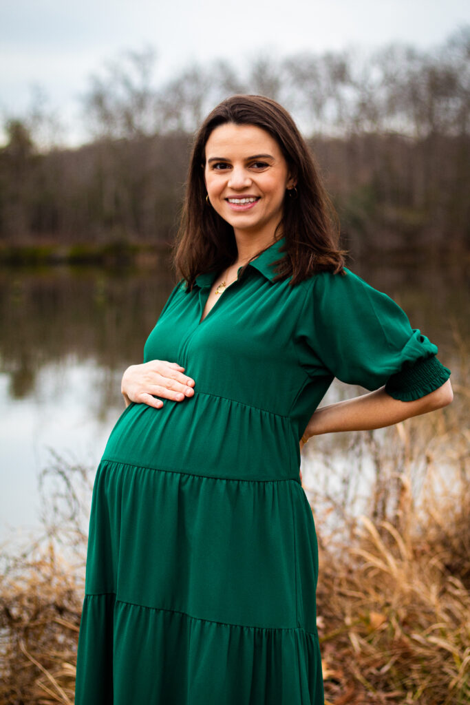 Family Maternity Portrait of mom with her hand on her belly.