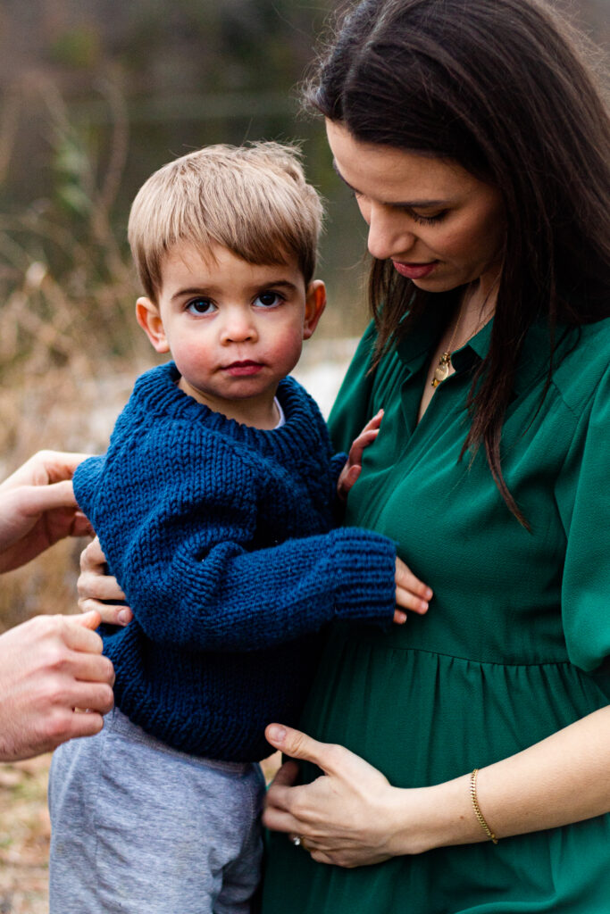 Maternity session family photo with toddler and mother.