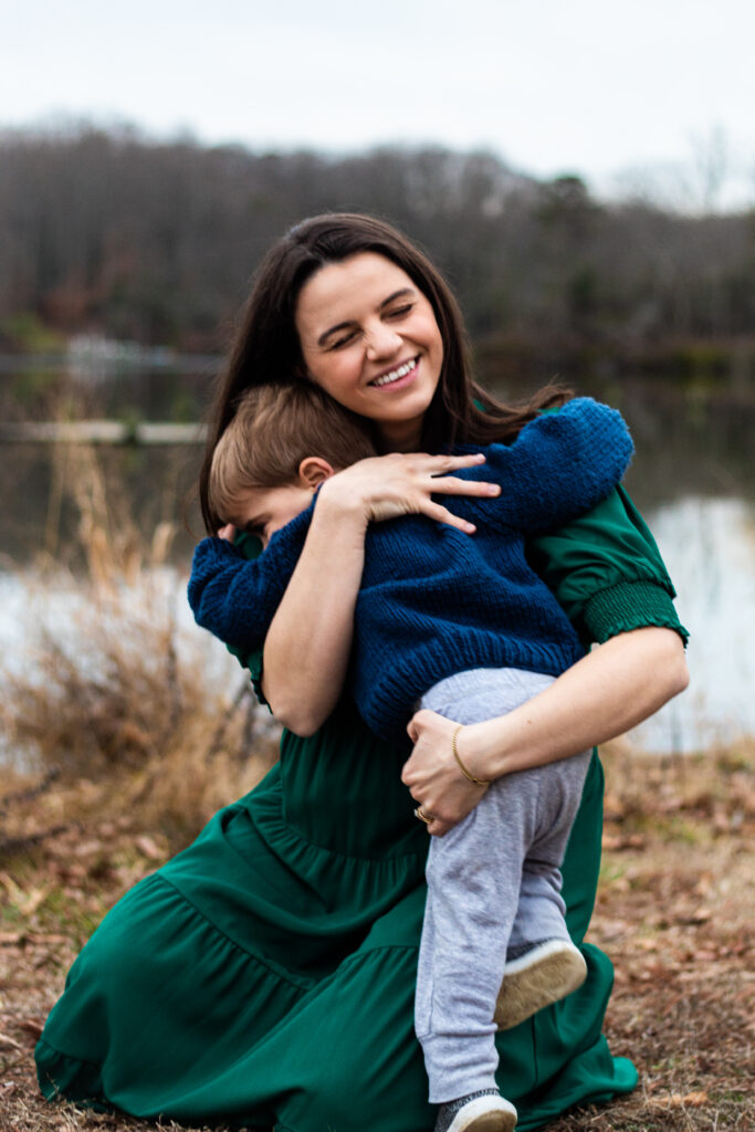 Maternity session family photo with toddler and mother hugging each other