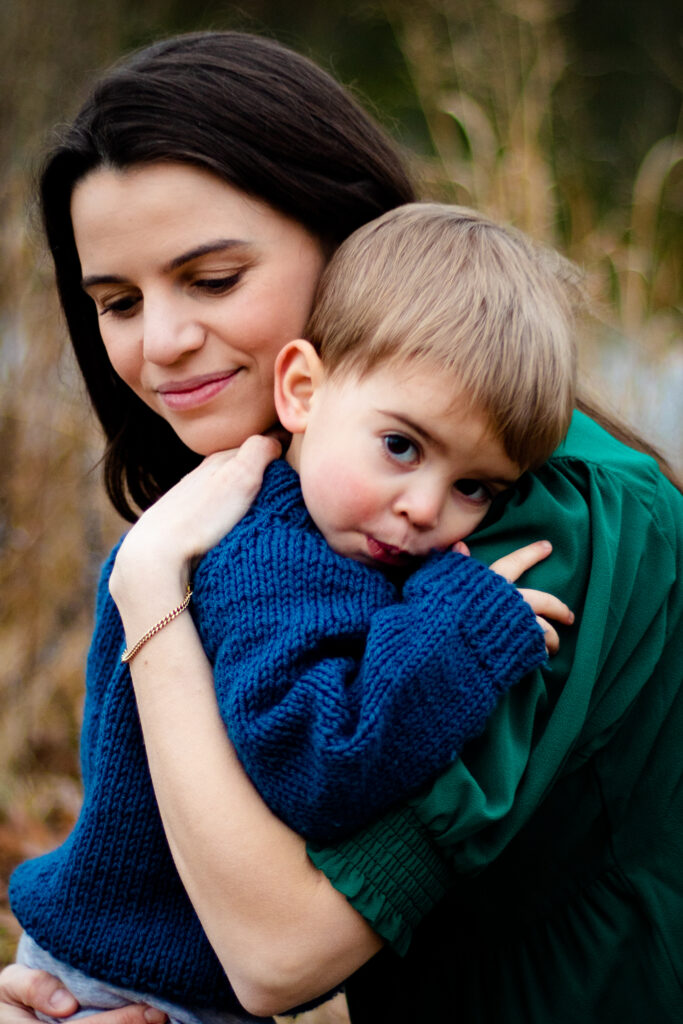 Maternity session family photo with toddler and mother hugging each other